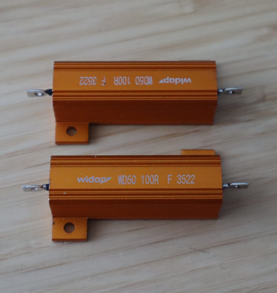 A pair of 100 Ω / 50 W wire wound resistors.